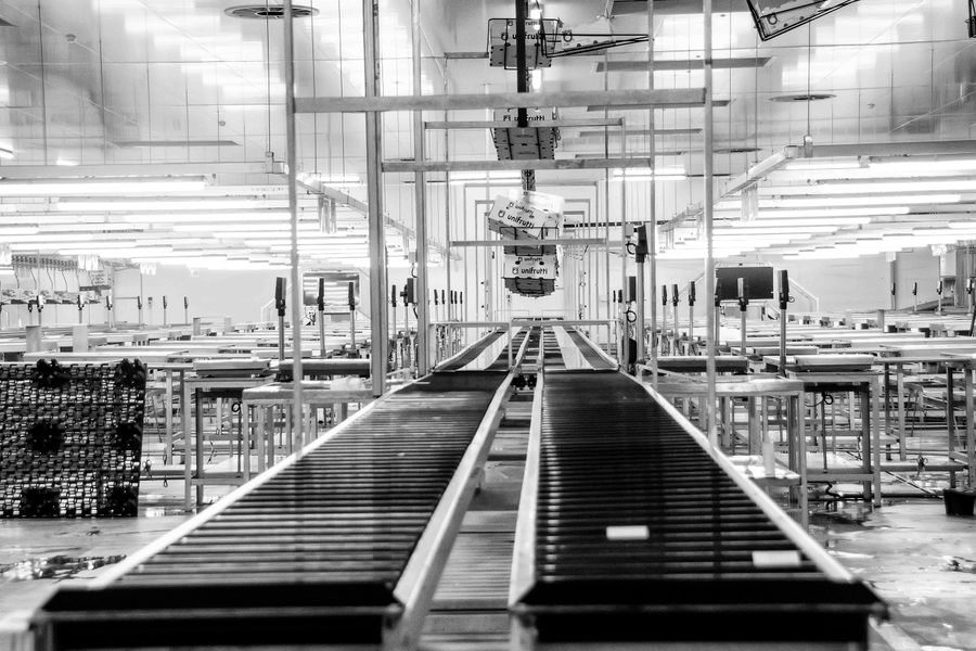 Industrielles Förderband in einer Produktionshalle in Schwarz-Weiß-Ansicht