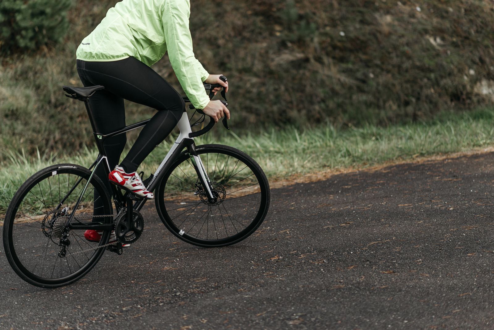 Radfahrer auf einem Schotterweg durch grüne Landschaft